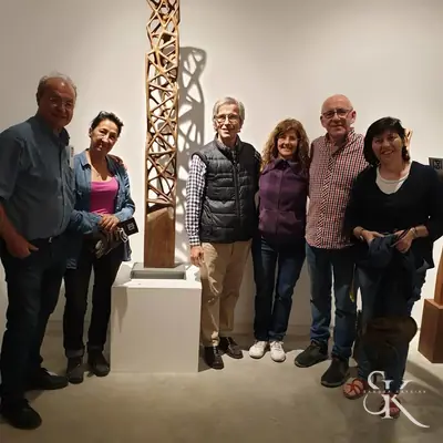 Grupo junto a una escultura vertical