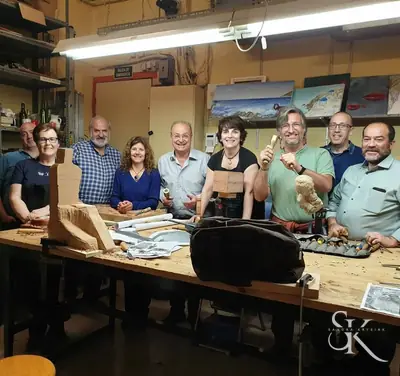 Grupo sonriente con una pieza sobre el banco