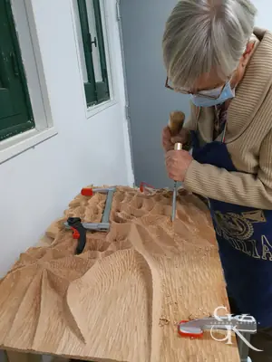 Alumna tallando un gran relieve
